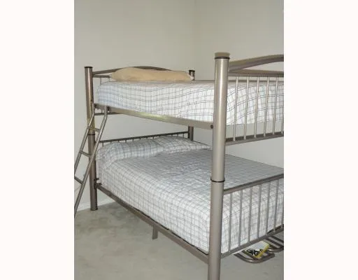 a bedroom with a bed and white walls