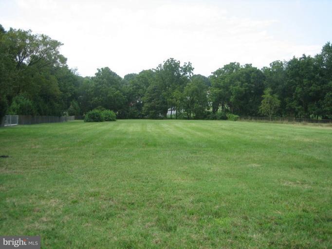 7340 Manchester Road Dundalk, MD 21222 - Photo 1 of 2 a view of a field with trees in the background