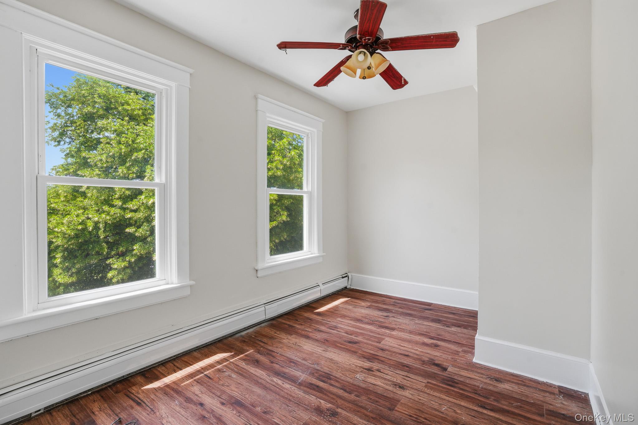 65 North Clinton Street Poughkeepsie, NY 12601 - Photo 29 of 43 an empty room with wooden floor chandelier fan and windows