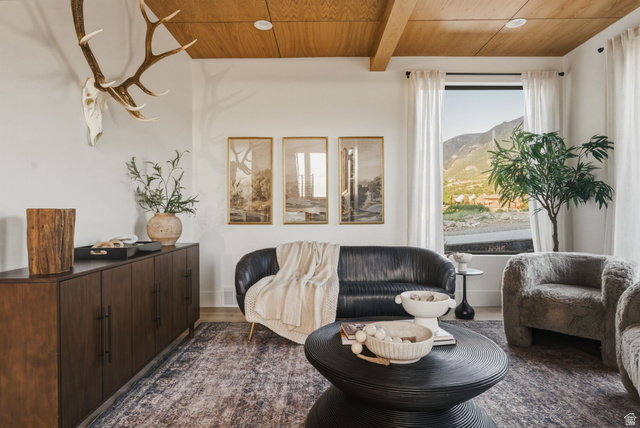 923 North Emery Lane Elk Ridge, UT 84651 - Photo 6 of 101 Spacious living area featuring a wood-finish ceiling with exposed beams, a large window with mountain scenery, and light wood-finish flooring