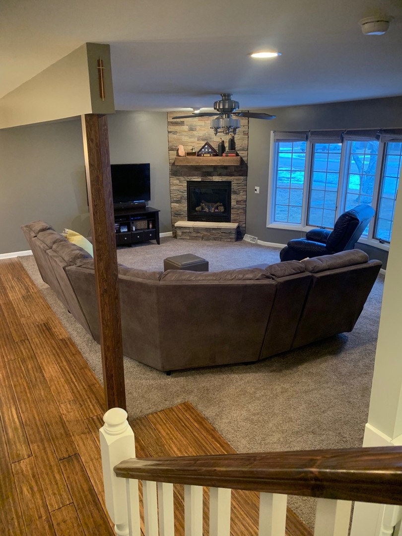 4473 East 250th Road Mendota, IL 61342 - Photo 5 of 15 a living room with furniture a flat screen tv and a fireplace