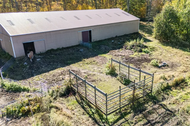 a view of a backyard with chairs and wooden fence