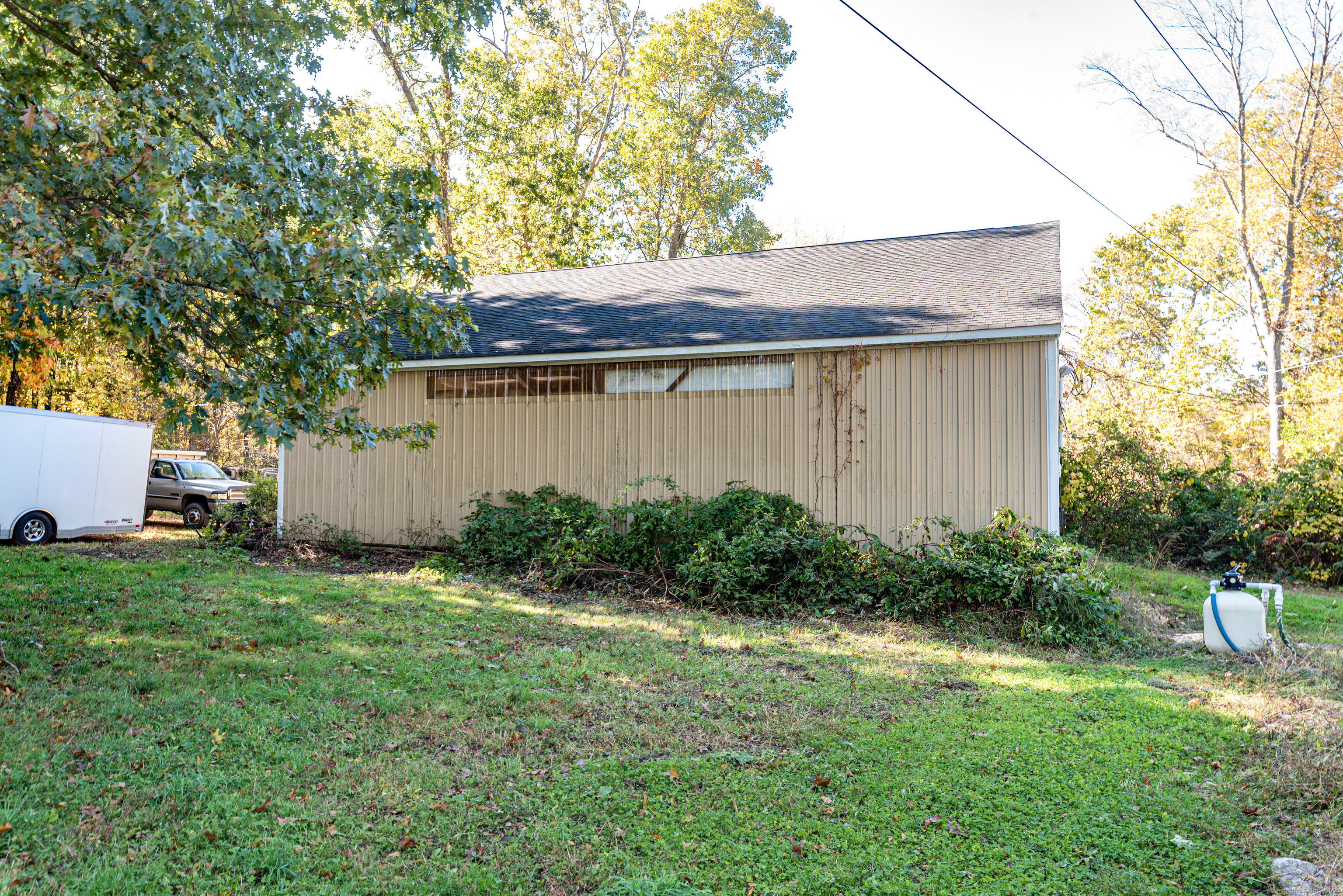 Undisclosed Address Windham, CT 06256 - Photo 6 of 39 a backyard of a house with plants and barbeque oven
