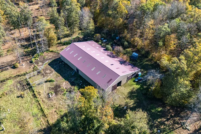an aerial view of a house with a yard