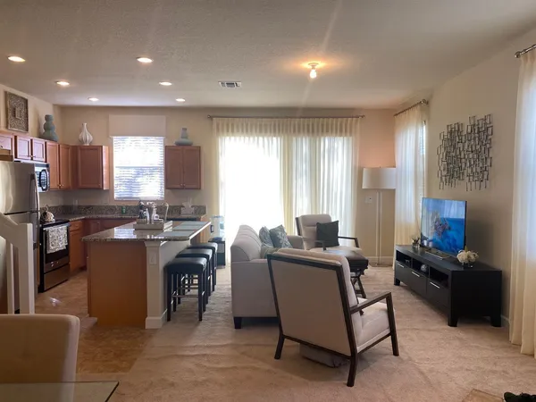 a view of kitchen with stainless steel appliances granite countertop sink stove and cabinets