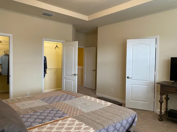 a bedroom with a bed and a flat screen tv