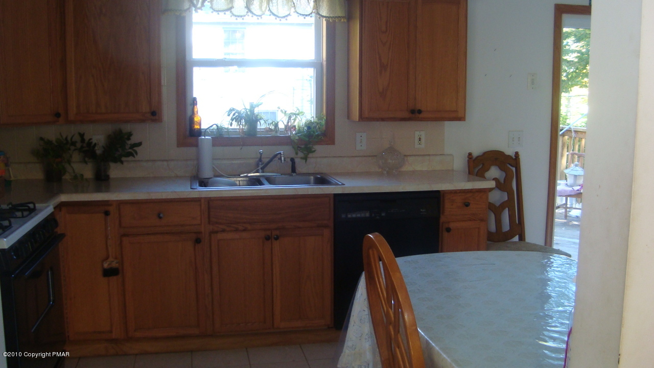 2024 Romeo Road Tobyhanna, PA 18466 - Photo 6 of 8 a kitchen with a sink a window and cabinets