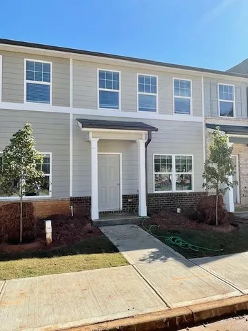a front view of a house with yard