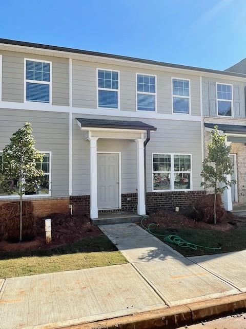 a front view of a house with yard
