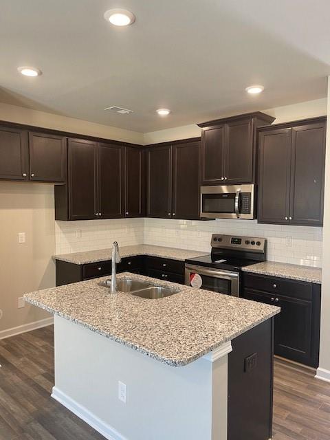 585 McWilliams Road Southeast, Unit 707 Atlanta, GA 30315 - Photo 2 of 10 a kitchen with kitchen island granite countertop stainless steel appliances a sink a stove a microwave and refrigerator