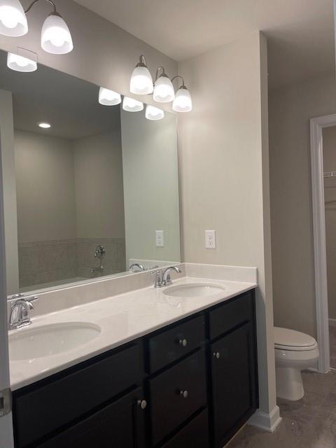585 McWilliams Road Southeast, Unit 707 Atlanta, GA 30315 - Photo 7 of 10 a bathroom with a sink a toilet and a large mirror