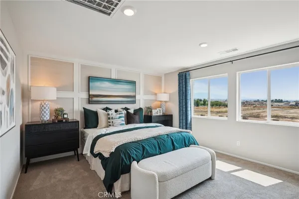 a bedroom with a bed and windows