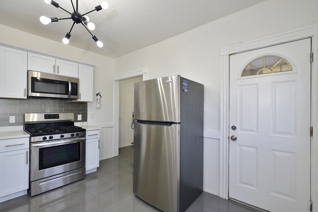 a kitchen with stainless steel appliances a refrigerator stove and microwave