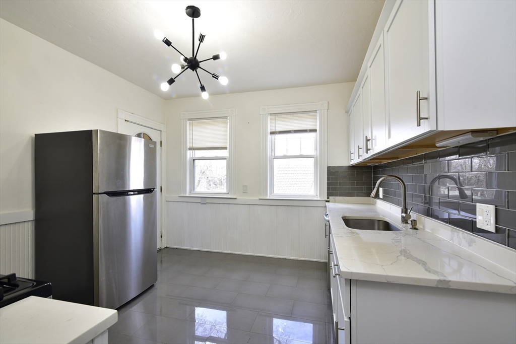 24 Rector Road, Unit 2 Boston, MA 02126 - Photo 2 of 17 a kitchen with stainless steel appliances granite countertop a microwave a refrigerator and a sink