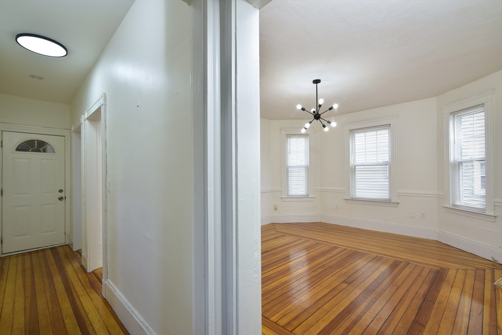 24 Rector Road, Unit 2 Boston, MA 02126 - Photo 7 of 17 wooden floor in an empty room with a window