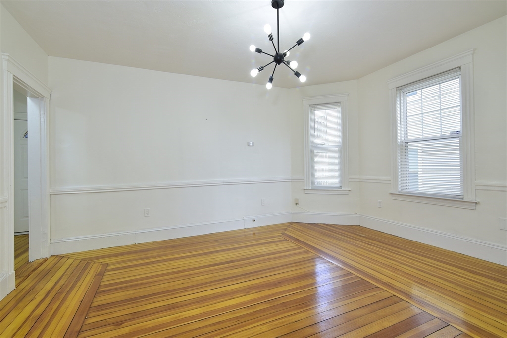 24 Rector Road, Unit 2 Boston, MA 02126 - Photo 8 of 17 a view of empty room with wooden floor and fan