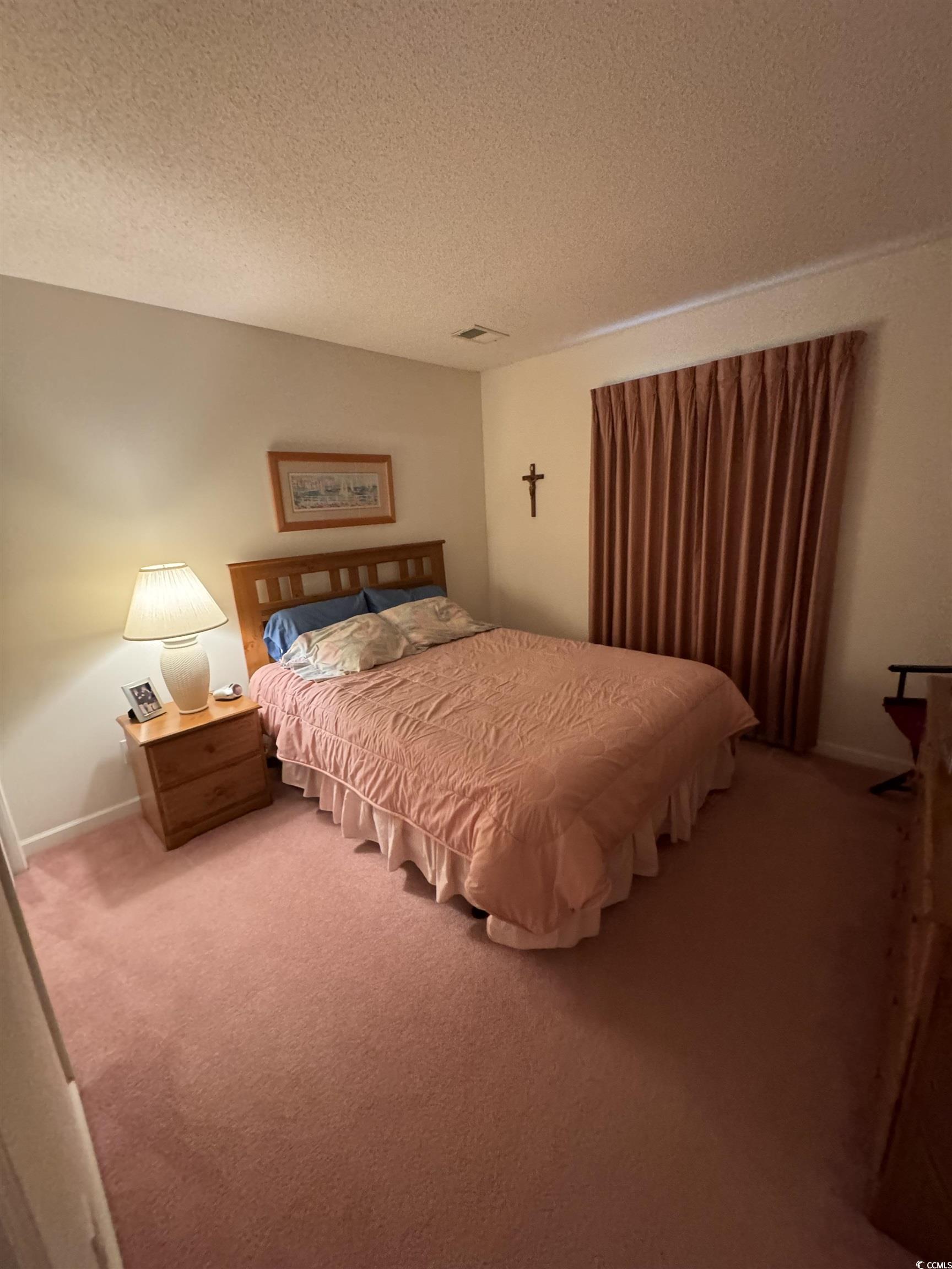 1900 Duffy Street, Unit J4 North Myrtle Beach, SC 29582 - Photo 15 of 22 Carpeted bedroom with a textured ceiling and baseboards