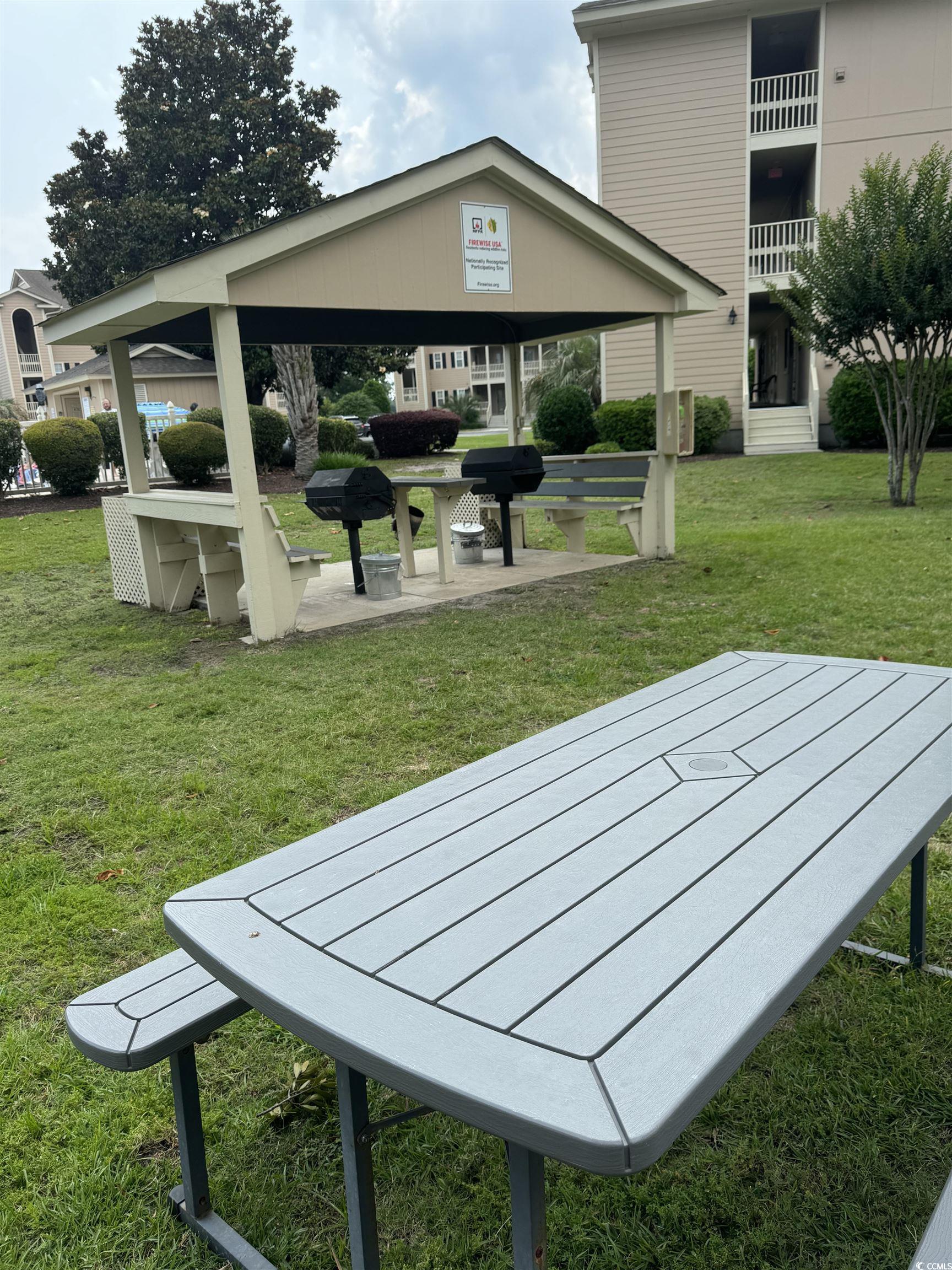 1900 Duffy Street, Unit J4 North Myrtle Beach, SC 29582 - Photo 20 of 22 Surrounding community with a yard and a patio area