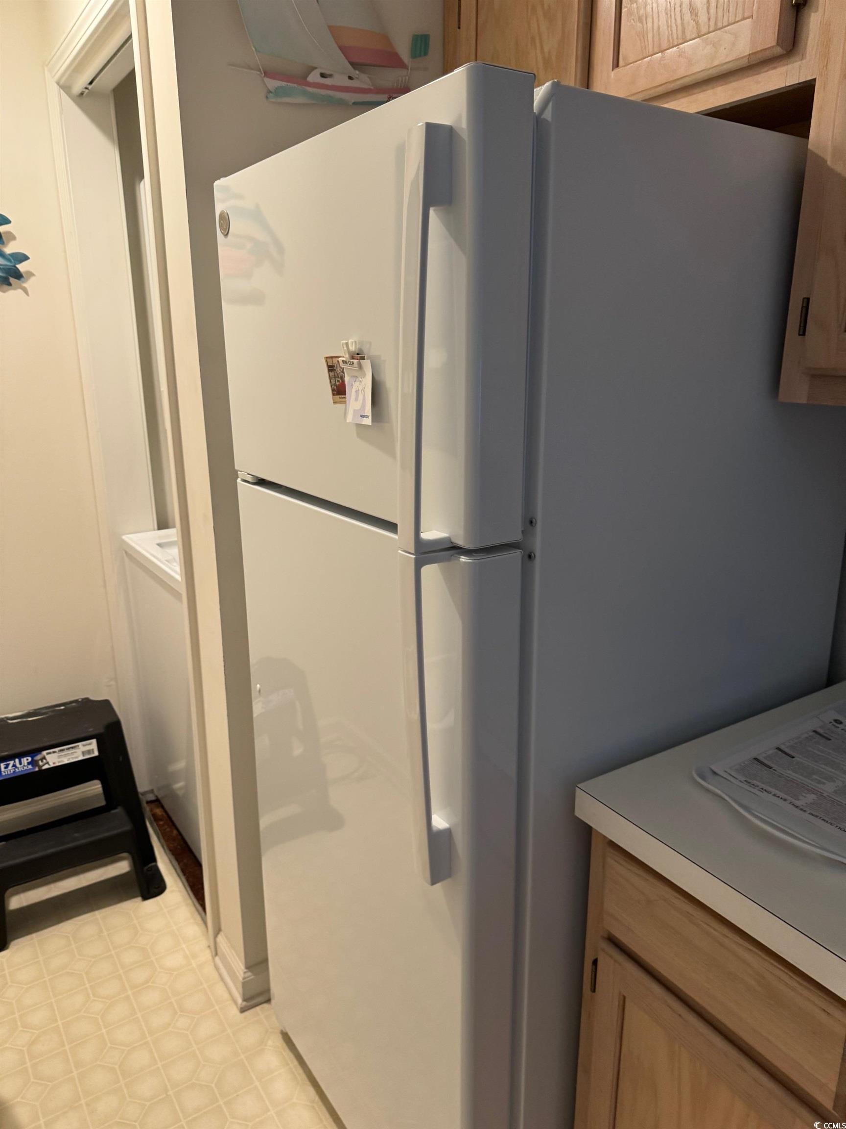 1900 Duffy Street, Unit J4 North Myrtle Beach, SC 29582 - Photo 5 of 22 Kitchen featuring freestanding refrigerator, light brown cabinets, and light countertops