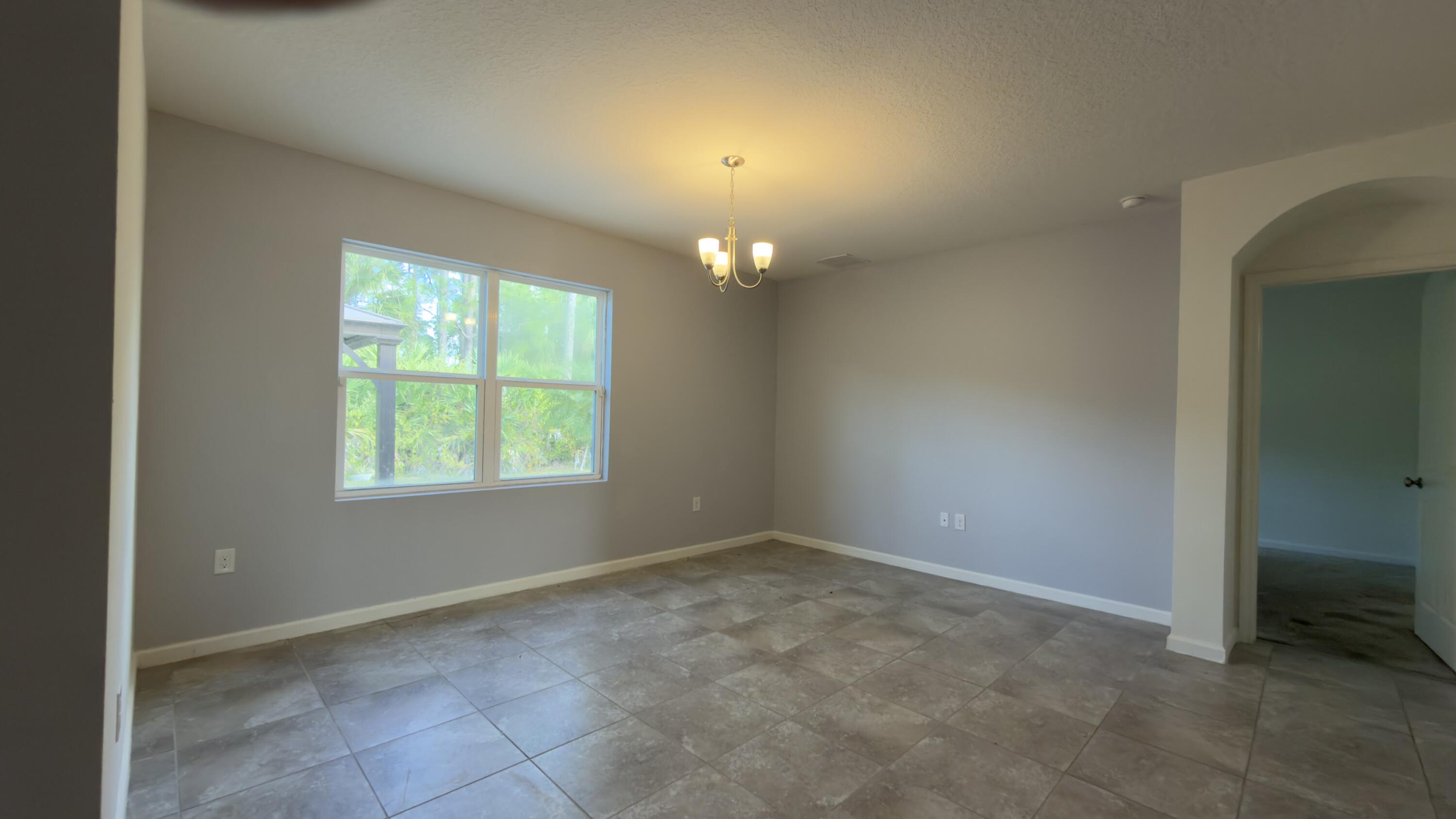 1117 Southwest Goodman Avenue Port St. Lucie, FL 34953 - Photo 12 of 18 an empty room with windows and closet