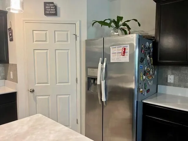 a kitchen with stainless steel appliances kitchen island a refrigerator sink and cabinets