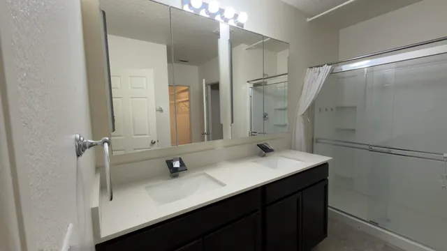 a bathroom with a sink vanity mirror and toilet