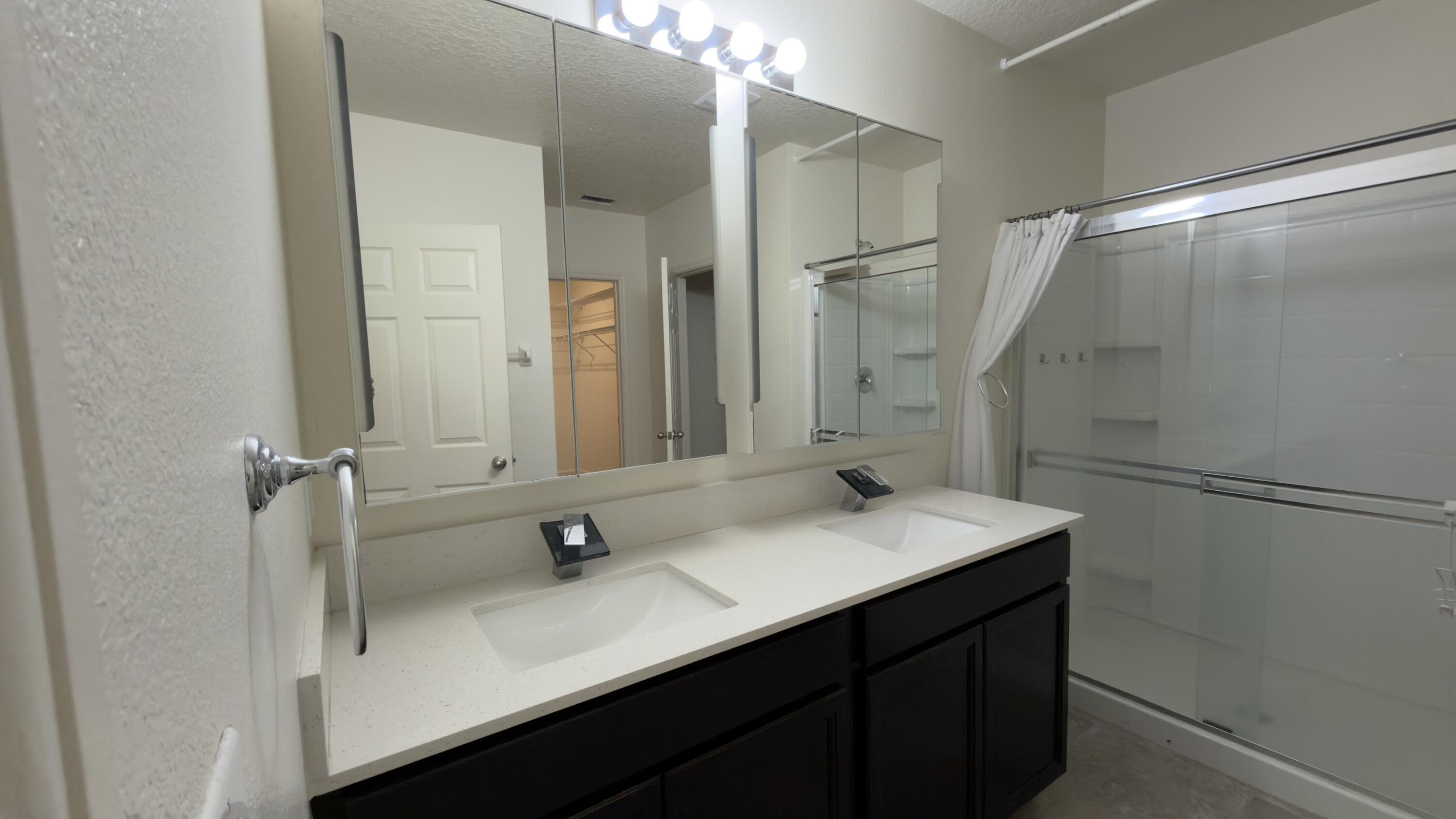 1117 Southwest Goodman Avenue Port St. Lucie, FL 34953 - Photo 10 of 18 a bathroom with a sink and mirror