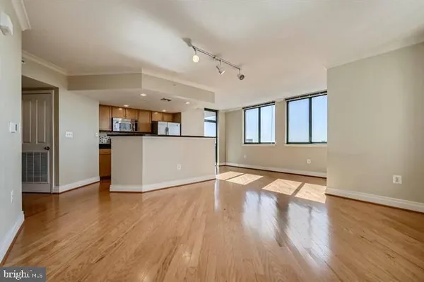 a view of a kitchen with wooden floor and electronic appliances