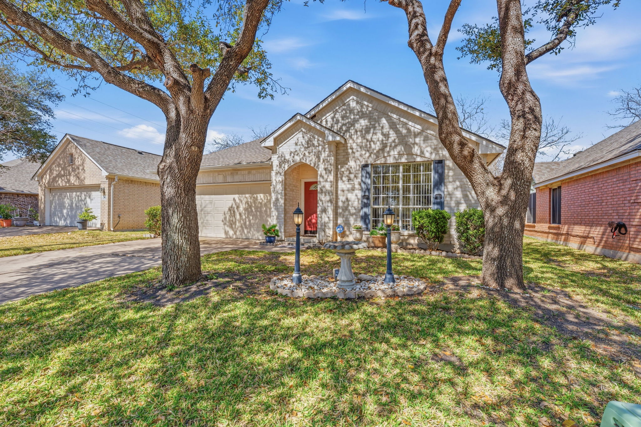 a view of a house with a tree in the yard