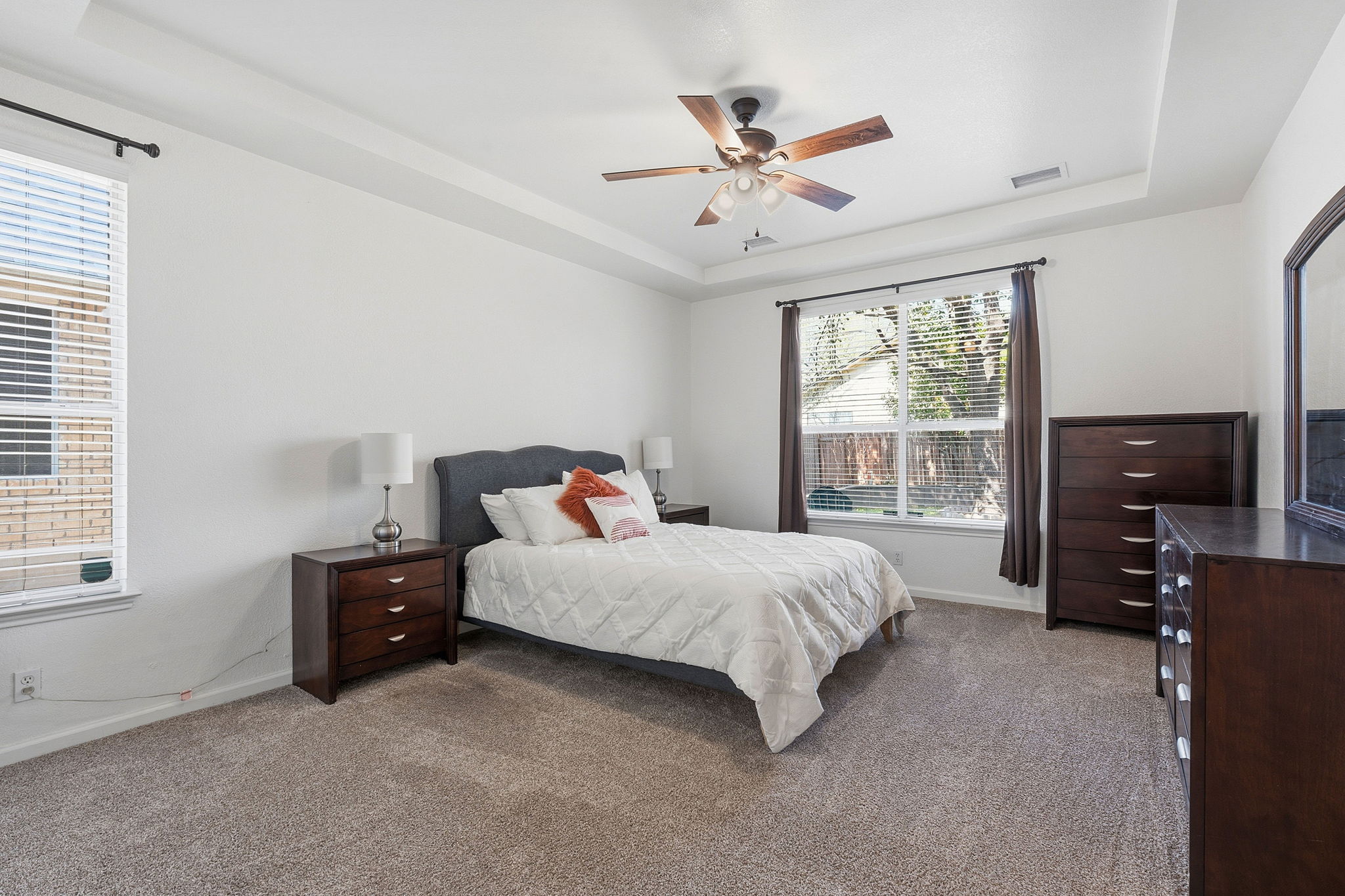 12716 Withers Way Austin, TX 78727 - Photo 13 of 29 a bedroom with a bed and a flat tv screen on the dresser