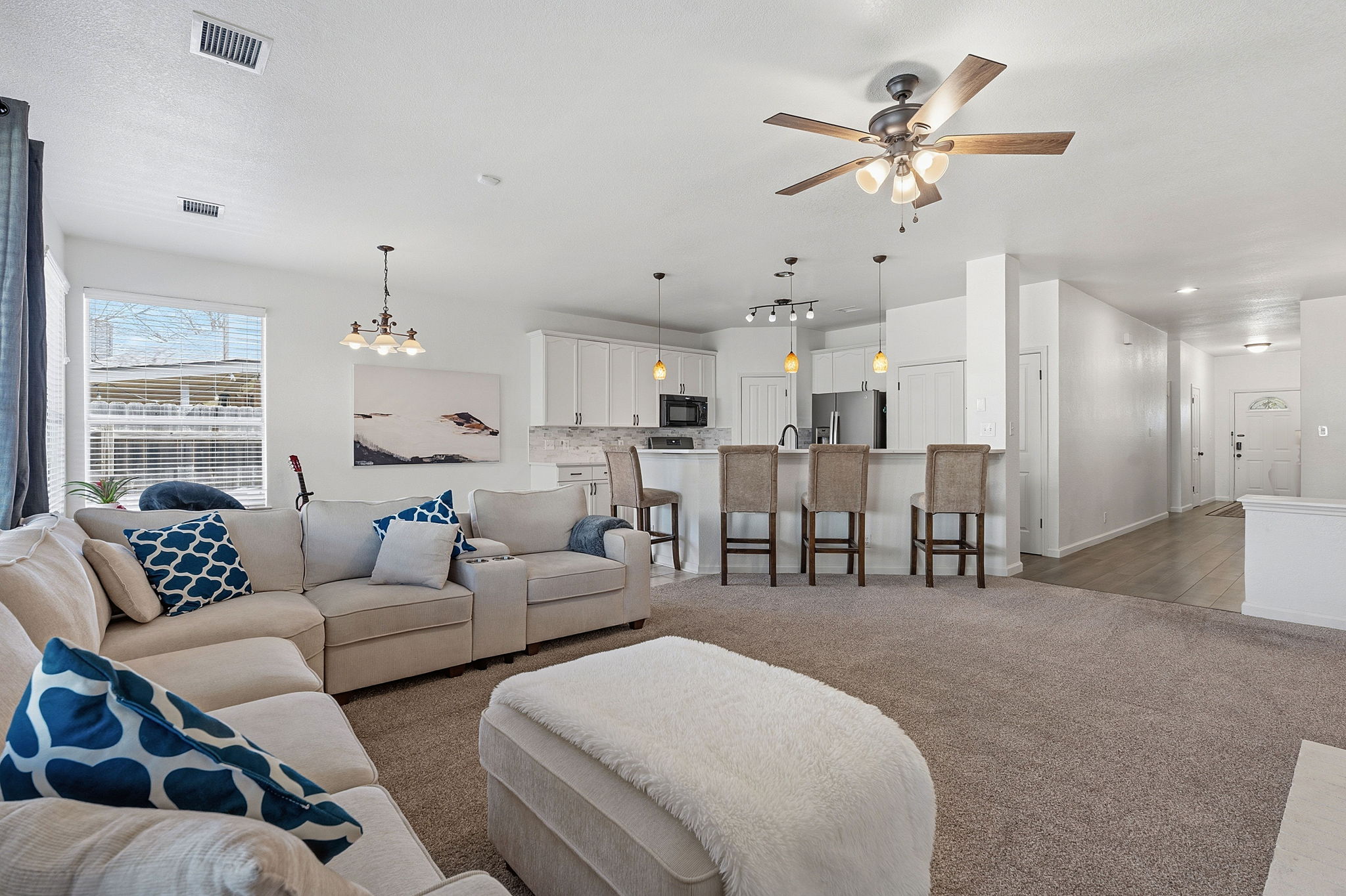 12716 Withers Way Austin, TX 78727 - Photo 3 of 29 a living room with furniture kitchen view and a chandelier