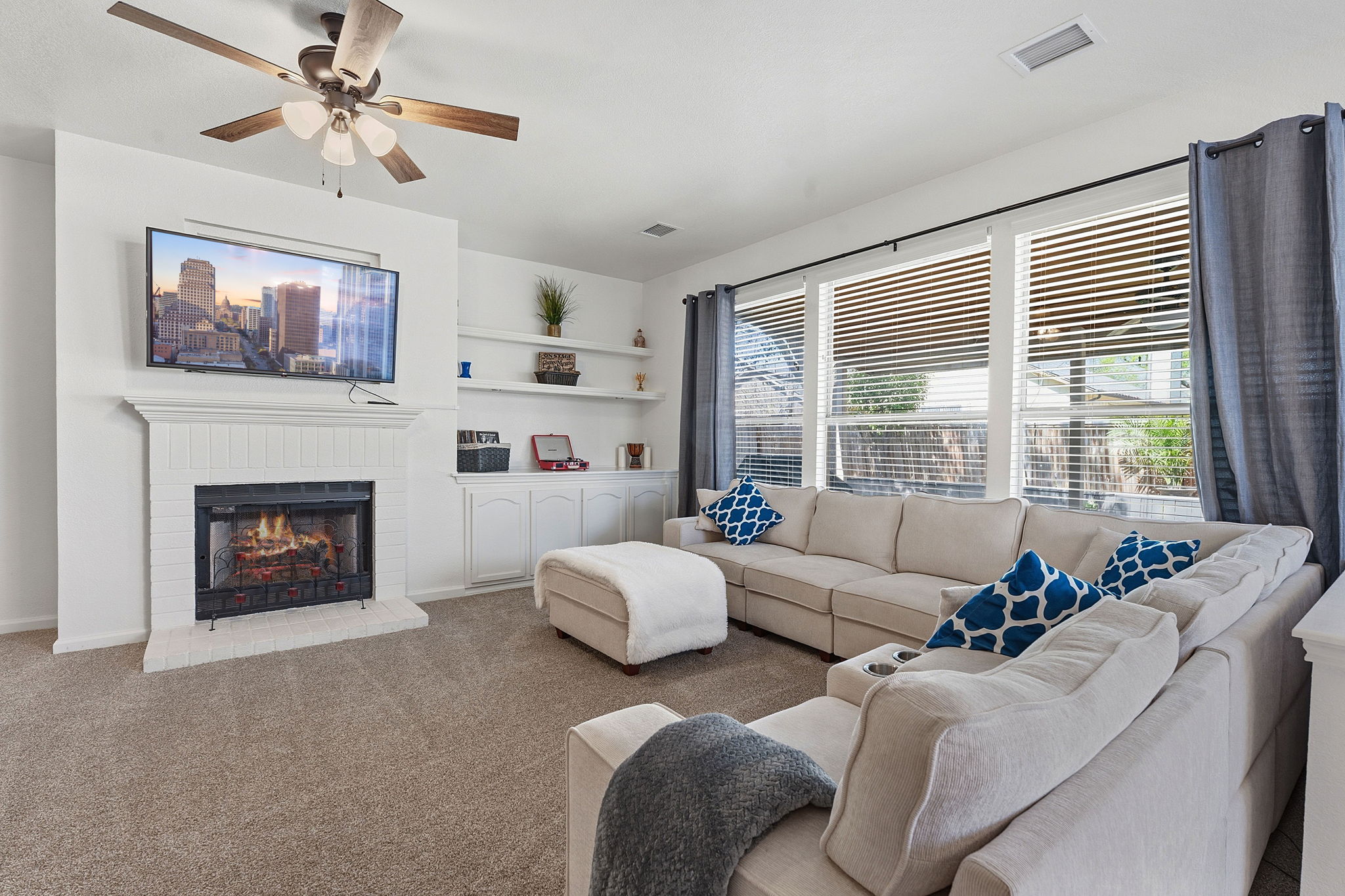 12716 Withers Way Austin, TX 78727 - Photo 4 of 29 a living room with furniture a fireplace and a flat screen tv