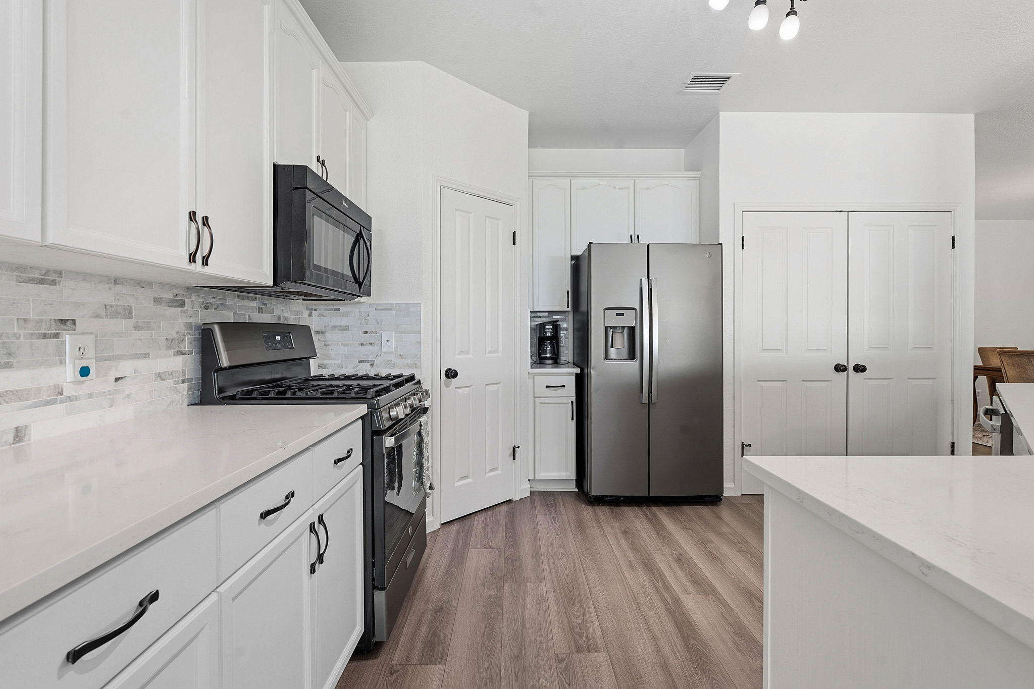 12716 Withers Way Austin, TX 78727 - Photo 8 of 29 a kitchen with stainless steel appliances a refrigerator stove and sink