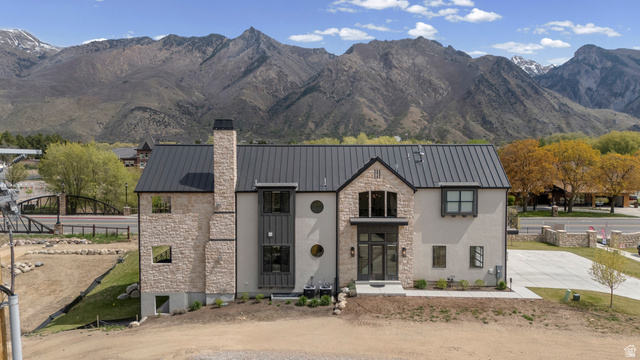 250 South Main Street, Unit 24 Alpine, UT 84004 - Photo 2 of 50 View of front of home with stone siding, a mountain view, a chimney, and a standing seam roof