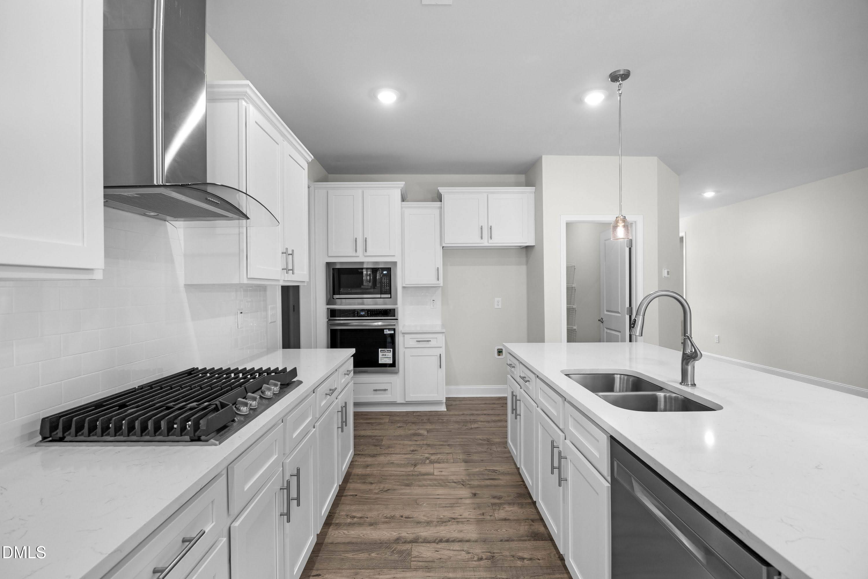 227 Galway Road Lillington, NC 27546 - Photo 12 of 36 a kitchen with stainless steel appliances a sink stove and refrigerator