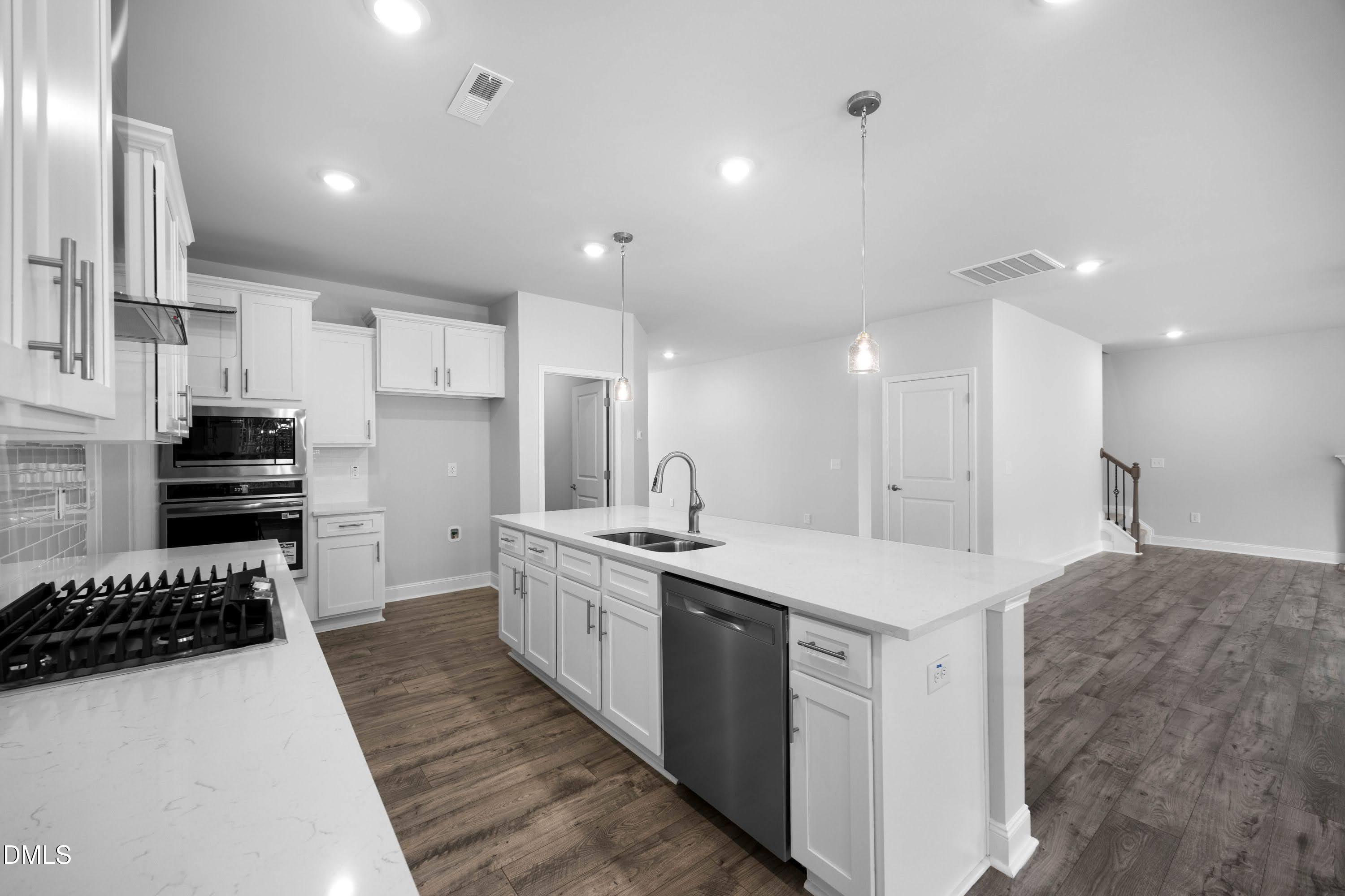 227 Galway Road Lillington, NC 27546 - Photo 14 of 36 a kitchen with a sink and white cabinets