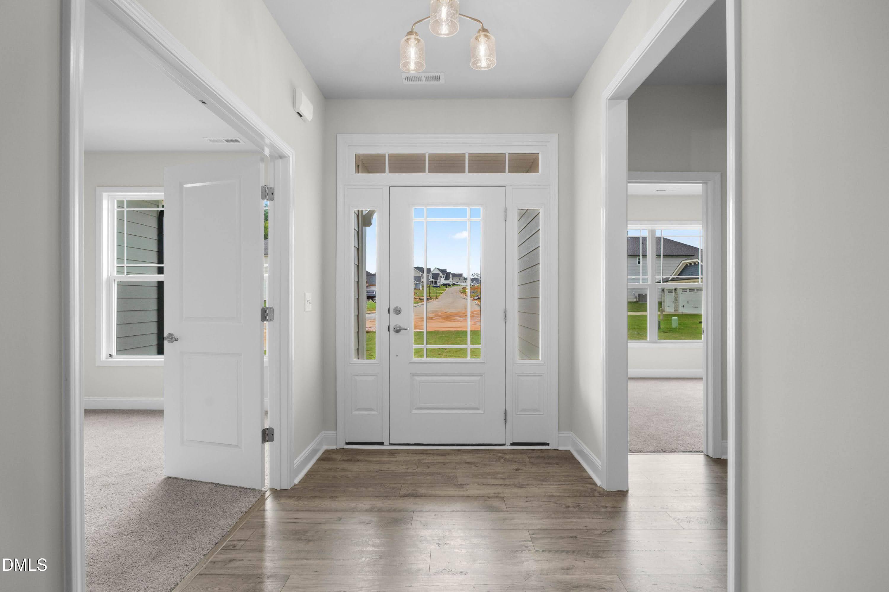 227 Galway Road Lillington, NC 27546 - Photo 2 of 36 an empty room with wooden floor and windows