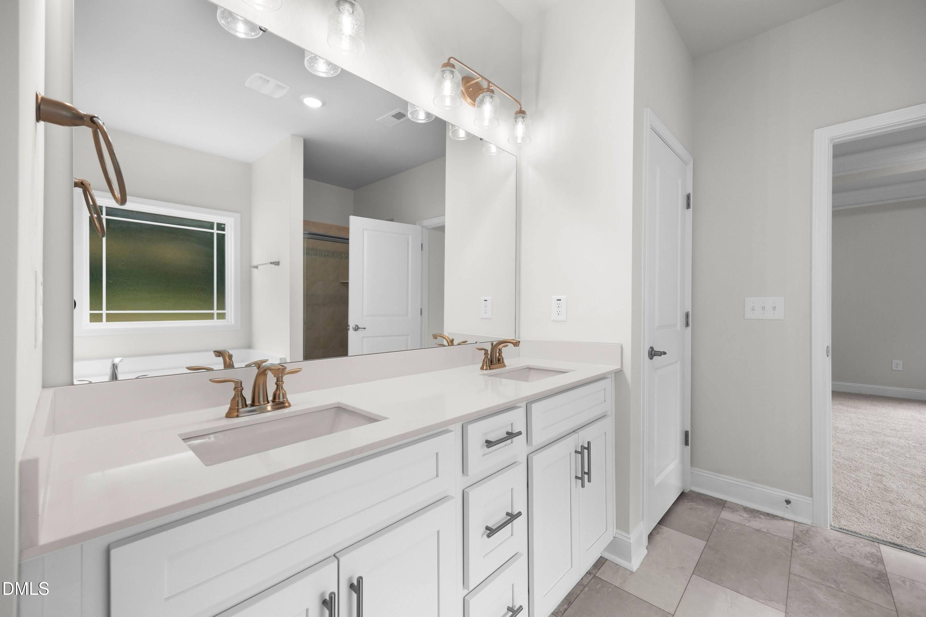 227 Galway Road Lillington, NC 27546 - Photo 21 of 36 a bathroom with double sink and a mirror
