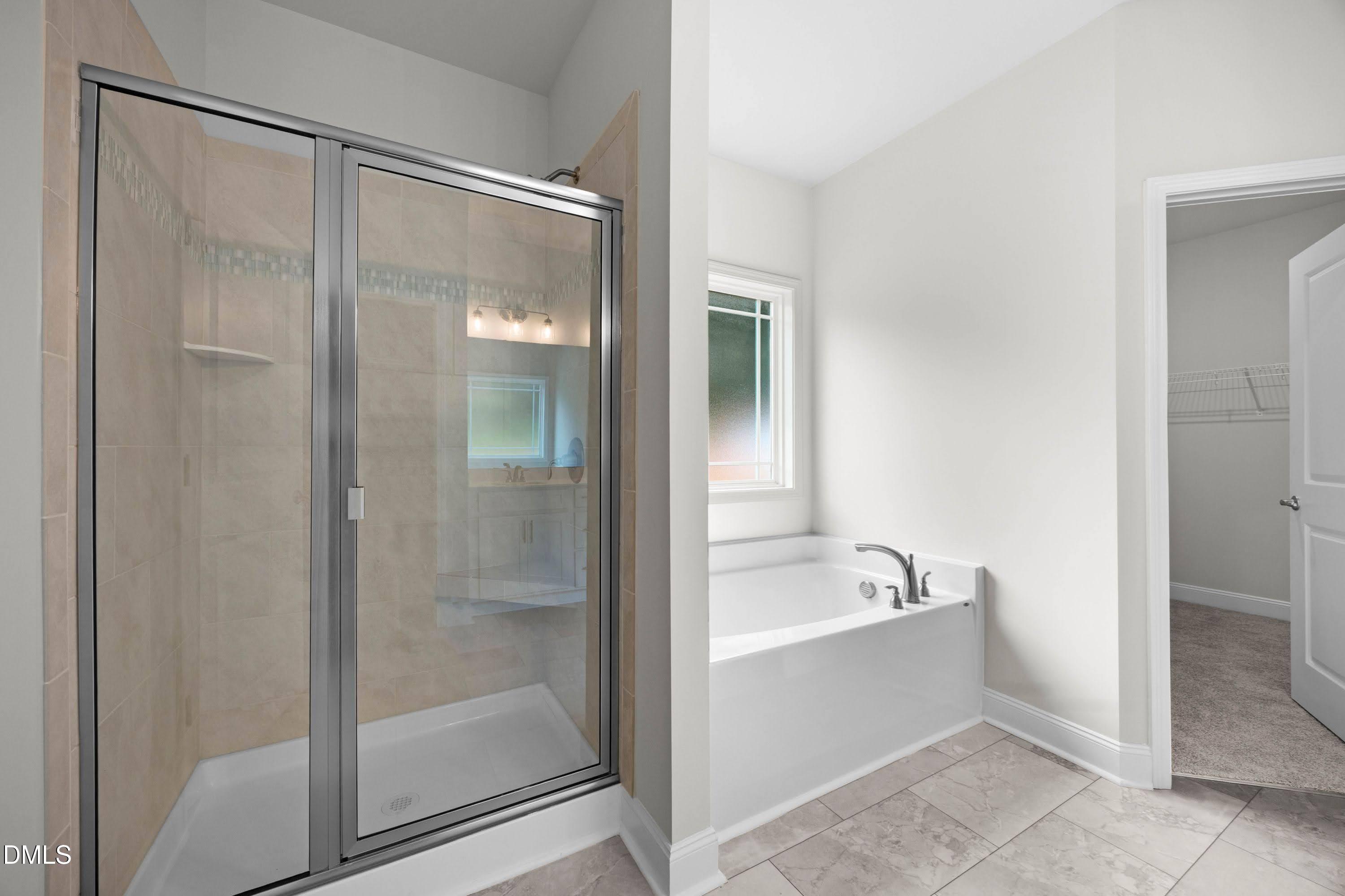 227 Galway Road Lillington, NC 27546 - Photo 22 of 36 a bathroom with a bathtub and a shower