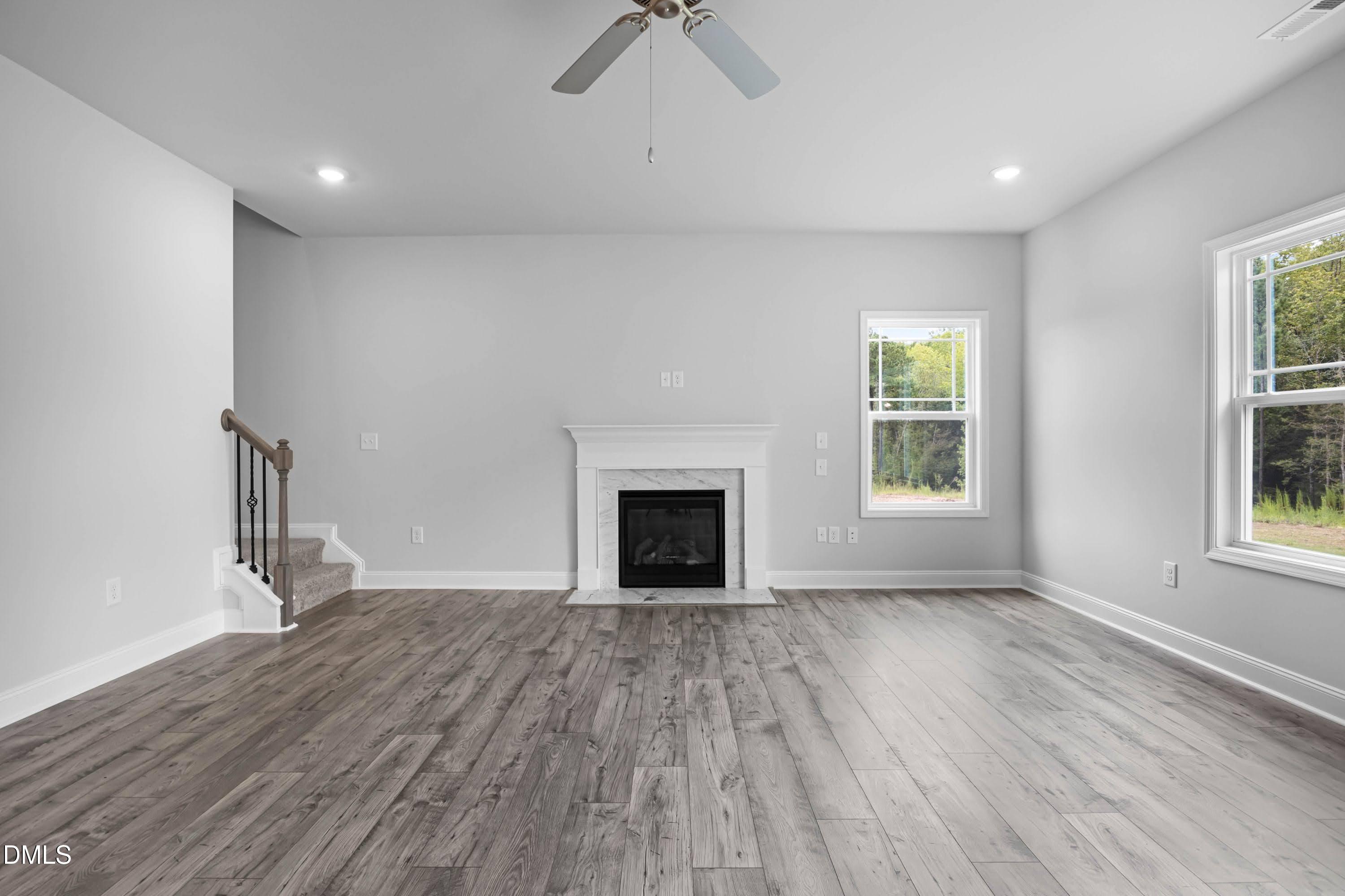 227 Galway Road Lillington, NC 27546 - Photo 5 of 36 an empty room with windows and fireplace