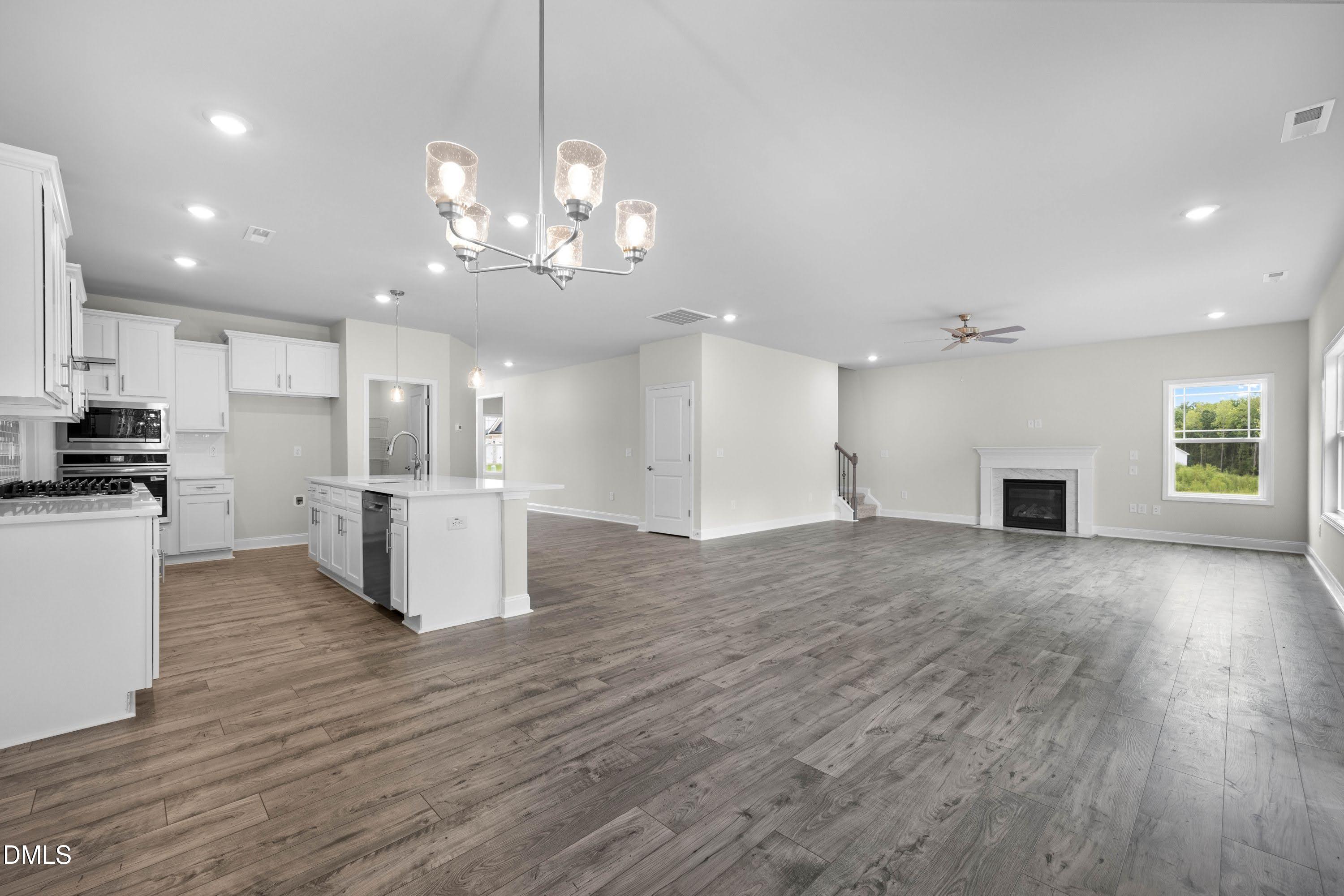 227 Galway Road Lillington, NC 27546 - Photo 9 of 36 a view of a big room with chandelier and kitchen view