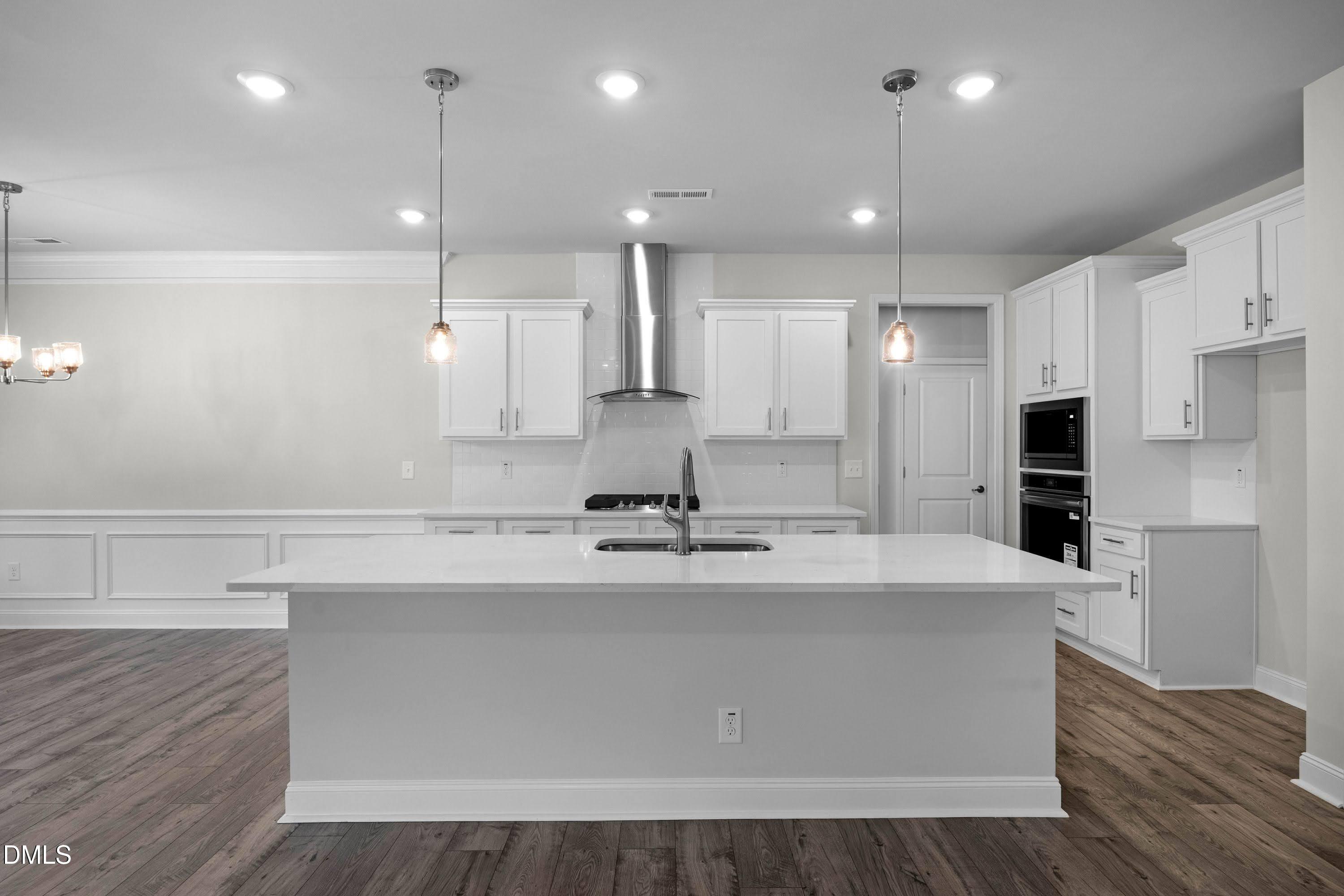 227 Galway Road Lillington, NC 27546 - Photo 10 of 36 a large kitchen with stainless steel appliances kitchen island a large counter top and a refrigerator
