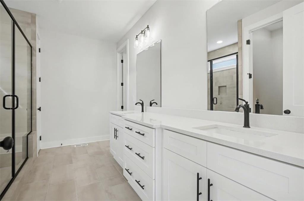 16 Altar Rock Court Cartersville, GA 30121 - Photo 32 of 52 a bathroom with double vanity sink and mirror