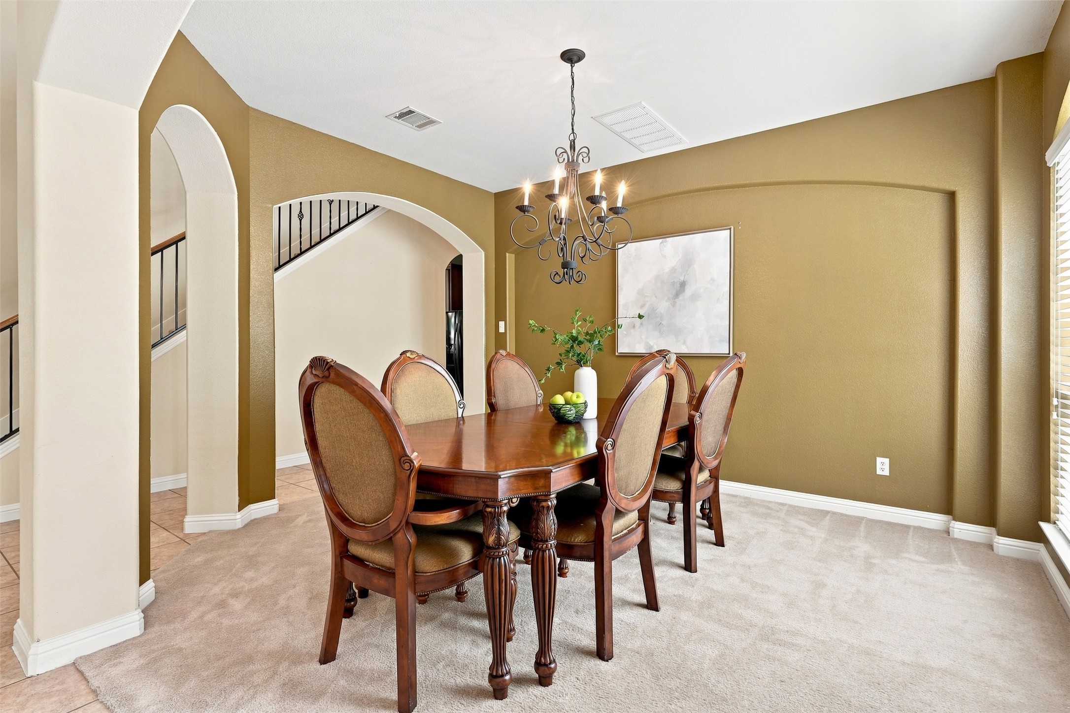 Elegant arched entryways and detailed moldings frame this classic formal dining space.