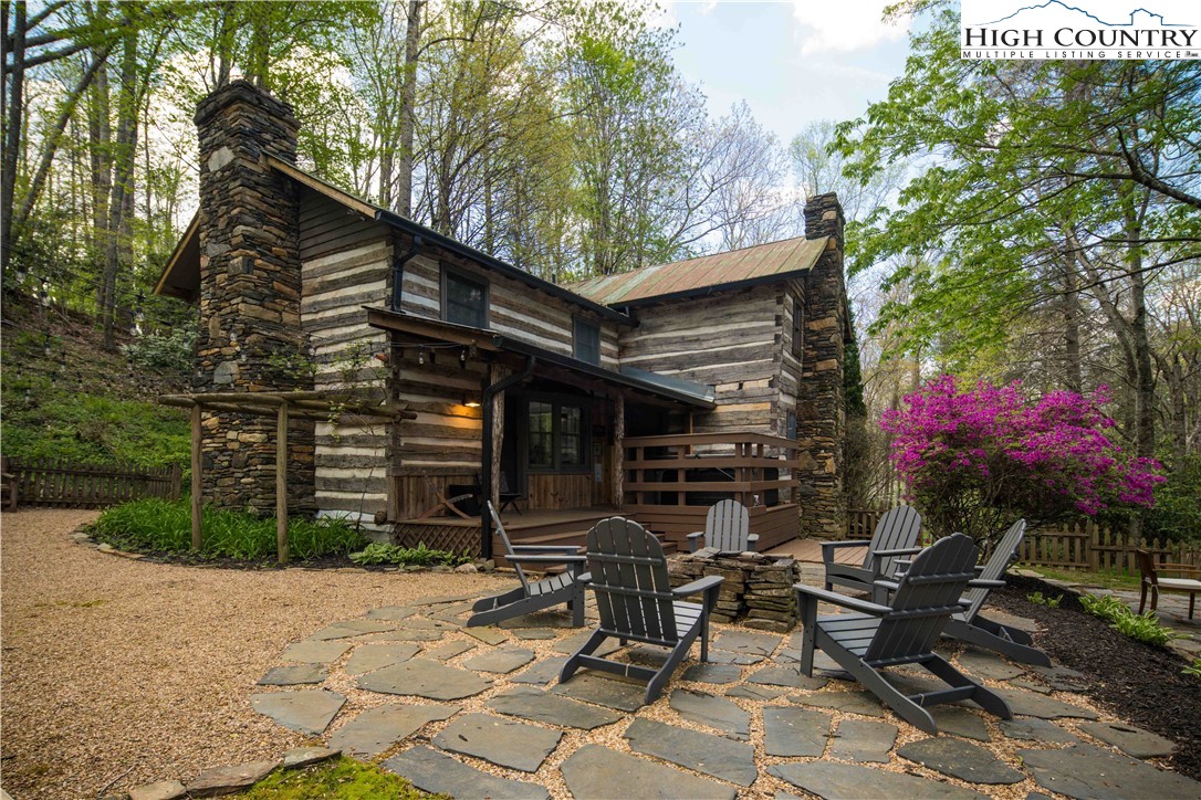 a view of a chairs and tables in the back yard of the house