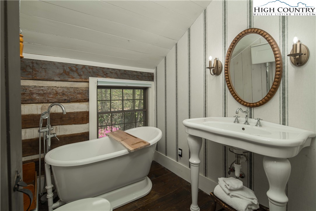 1534 Highway 194 Boone, NC 28607 - Photo 27 of 50 a bathroom with a toilet a sink and a mirror