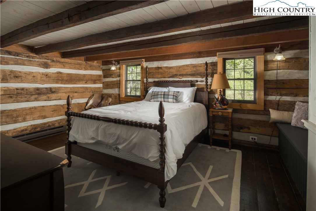 1534 Highway 194 Boone, NC 28607 - Photo 31 of 50 a bed sitting in a bedroom next to a window