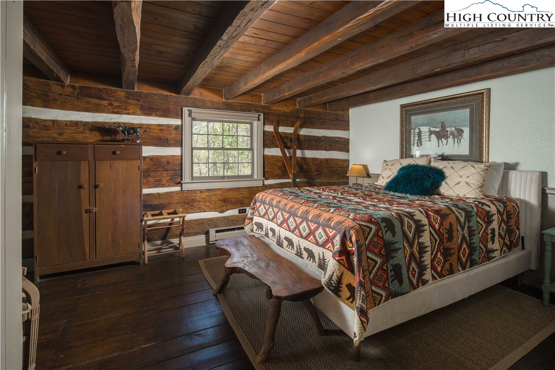 1534 Highway 194 Boone, NC 28607 - Photo 32 of 50 a bed sitting in a spacious bedroom next to a window