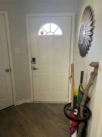 a kitchen with stainless steel appliances granite countertop a refrigerator stove and white cabinets