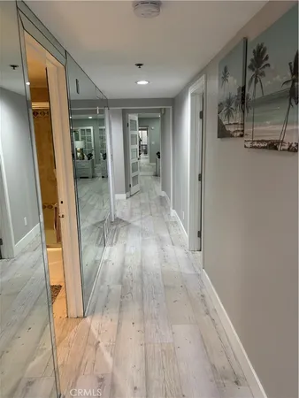 a view of hallway with furniture and wooden floor